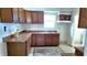 Functional kitchen featuring wood cabinetry, a double sink, and ample counter space for meal preparation at 1148 N Pershing Ave, Indianapolis, IN 46222