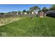 Expansive fenced backyard with lush grass and shed provides a private outdoor oasis at 1214 Lindsey Ln, Lebanon, IN 46052