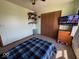 Bedroom with a plaid bedspread, a closet, shelving, a TV, and pink heart-shaped decor at 1214 Lindsey Ln, Lebanon, IN 46052