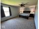 Cozy bedroom with a large window and neutral carpet, perfect for relaxation at 1214 Lindsey Ln, Lebanon, IN 46052