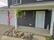 Front porch with well-kept landscaping and an American flag at 1214 Lindsey Ln, Lebanon, IN 46052