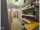Hallway with carpet and shelves with books on the walls for showcasing at 1214 Lindsey Ln, Lebanon, IN 46052