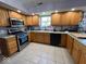Well-lit kitchen features ample cabinet space, modern appliances, and tile flooring at 1214 Lindsey Ln, Lebanon, IN 46052