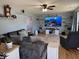 Spacious living room featuring large TV, wood floors, and comfortable seating at 1214 Lindsey Ln, Lebanon, IN 46052