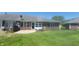 Spacious backyard with a brick patio, lush green lawn, and mature landscaping at 123 Old Farm Rd, Danville, IN 46122