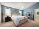 This primary bedroom boasts stylish decor, a large bed, and plenty of natural light from two windows at 12446 Deerview Dr, Noblesville, IN 46060