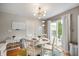 Bright dining area with a modern chandelier and sliding glass doors to backyard at 12446 Deerview Dr, Noblesville, IN 46060