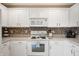 Modern kitchen with white cabinets, stainless steel appliances, and stylish backsplash at 12446 Deerview Dr, Noblesville, IN 46060