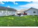 Expansive backyard with a spacious patio, outdoor seating, and a well-manicured lawn at 12681 E 79Th St, Indianapolis, IN 46236