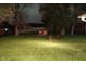 Night view of backyard featuring playset, fire pit and seating at 12681 E 79Th St, Indianapolis, IN 46236