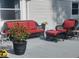 Cozy outdoor seating area with wicker furniture and vibrant red cushions on a backyard patio at 12681 E 79Th St, Indianapolis, IN 46236