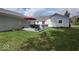 Spacious backyard with a gray patio, outdoor seating, lush lawn, and well-maintained landscaping at 12681 E 79Th St, Indianapolis, IN 46236