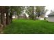 Expansive backyard featuring lush green grass, mature trees, and a playset at 12681 E 79Th St, Indianapolis, IN 46236