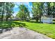 Lush green backyard with a large storage shed, some playground equipment, and a yard at 12681 E 79Th St, Indianapolis, IN 46236