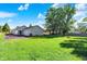 Large backyard with shed and detached garage, under a blue sky and green lawn at 12681 E 79Th St, Indianapolis, IN 46236