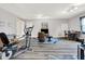 Finished basement features exercise equipment, neutral paint, and light wood-look flooring at 12681 E 79Th St, Indianapolis, IN 46236