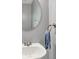 Bathroom with round mirror, gray walls, and towel on the towel rack at 12681 E 79Th St, Indianapolis, IN 46236