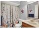 Cozy bathroom with shower/tub combination, floral curtain, and decorative mirror at 12681 E 79Th St, Indianapolis, IN 46236