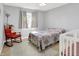 Cozy bedroom with rocking chair, crib, and natural light through the window at 12681 E 79Th St, Indianapolis, IN 46236