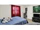 Bedroom featuring neutral carpet and a bed with blue coverlet and red window coverings at 12681 E 79Th St, Indianapolis, IN 46236