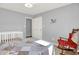 Comfortable bedroom with rocking chair, crib, and a double closet at 12681 E 79Th St, Indianapolis, IN 46236
