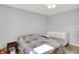Comfortable bedroom with crib, neutral carpet, and a bed with patchwork coverlet at 12681 E 79Th St, Indianapolis, IN 46236