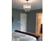 Bedroom featuring a crystal chandelier, neutral paint, and white doors at 12681 E 79Th St, Indianapolis, IN 46236