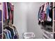 Walk-in closet with hanging clothes and storage, with a plastic laundry basket at 12681 E 79Th St, Indianapolis, IN 46236