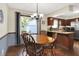 Inviting dining area featuring hardwood floors, a chandelier, and natural light from the window at 12681 E 79Th St, Indianapolis, IN 46236