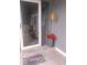 Close up on the front door, mat and floral display with front storm door at 12681 E 79Th St, Indianapolis, IN 46236