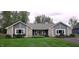 Beautiful single-story home with stone accents, gray siding, a well-manicured lawn and charming curb appeal at 12681 E 79Th St, Indianapolis, IN 46236