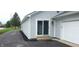 Exterior view of sliding glass door entry and attached garage on driveway at 12681 E 79Th St, Indianapolis, IN 46236