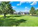 View of the home with lush lawn and mature trees providing shade and privacy at 12681 E 79Th St, Indianapolis, IN 46236