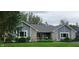 Charming single-story home featuring stone accents, gray siding, well-manicured lawn and covered porch at 12681 E 79Th St, Indianapolis, IN 46236