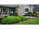 Inviting front porch with stone accents, a porch swing, cozy seating, and beautiful landscaping at 12681 E 79Th St, Indianapolis, IN 46236