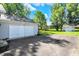 Exterior detached garage with a wide driveway, and a lush green lawn at 12681 E 79Th St, Indianapolis, IN 46236