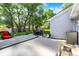 Landscaped backyard with a hot tub, outdoor seating, and mature trees along the fence line at 12681 E 79Th St, Indianapolis, IN 46236