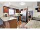 Modern kitchen with granite countertops, stainless steel appliances, and dark wood cabinetry at 12681 E 79Th St, Indianapolis, IN 46236