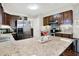 Spacious kitchen featuring granite counters, stainless appliances, and ample dark wood cabinet storage at 12681 E 79Th St, Indianapolis, IN 46236