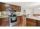 Functional kitchen with stainless steel appliances, granite countertops, and decorative tile backsplash at 12681 E 79Th St, Indianapolis, IN 46236