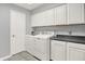 Laundry room with a washing machine, clothes dryer, and upper and lower cabinets at 12681 E 79Th St, Indianapolis, IN 46236