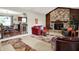 Cozy living room featuring a stone fireplace, wood paneling, and comfortable seating at 12681 E 79Th St, Indianapolis, IN 46236