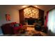 Cozy living room featuring a stone fireplace, comfortable seating, and natural lighting at 12681 E 79Th St, Indianapolis, IN 46236