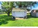 Detached shed in backyard with seating, green lawn, and mature tree at 12681 E 79Th St, Indianapolis, IN 46236