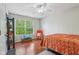 Bright bedroom features a ceiling fan, a large window, and hardwood floors at 13063 E 131St St, Fishers, IN 46037