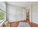 Cozy bedroom with wood floors, bright window, and multiple closets at 13063 E 131St St, Fishers, IN 46037