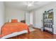 Well-lit bedroom with hardwood floors featuring open doors and a bookshelf at 13063 E 131St St, Fishers, IN 46037