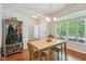 Cozy dining room with hardwood floors, natural light and coat rack at 13063 E 131St St, Fishers, IN 46037