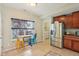 Bright kitchen features stainless steel refrigerator, dining nook with colorful chairs, and ample cabinet space at 13063 E 131St St, Fishers, IN 46037