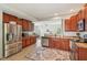 Traditional kitchen features wooden cabinets, stainless steel appliances, and an ornamental rug at 13063 E 131St St, Fishers, IN 46037